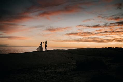 Silhouette of a Romantic Couple Standing on the Beach during Sunset ...