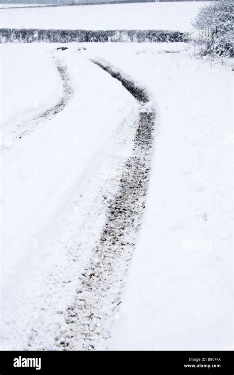 Tractor tracks in the snow Stock Photo - Alamy