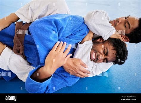 Men, martial arts and karate choke hold in dojo to practice fighting ...