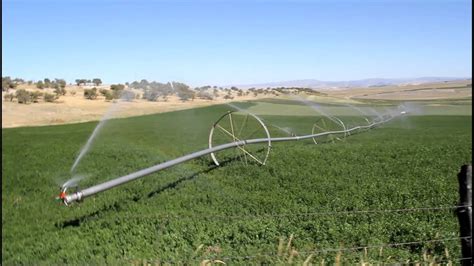 Pivot irrigation creates small rainbow - YouTube