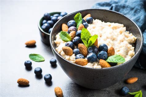 Oatmeal Porridge with Fresh Berries and Nuts. Stock Photo - Image of ...