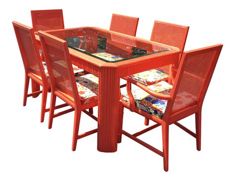 a dining table with six chairs and a glass top centerpiece in orange color on an isolated white ...