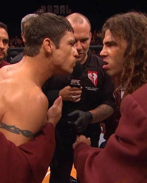 two men are talking to each other in the ring