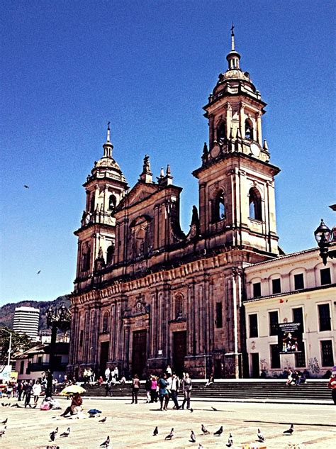 people are walking around in front of an old building with many spires ...