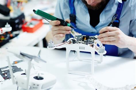 Free Photo | Fixing drone in maintenance shop