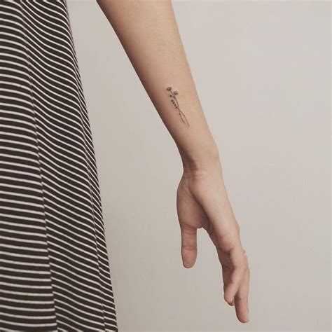 a woman with a small tattoo on her arm