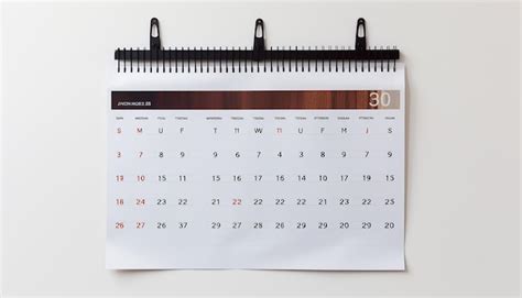 Premium AI Image | a wall calendar hanging on a white wall