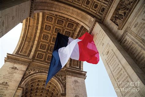 French flag waving under Arc de Triomphe Photograph by Elena Dijour - Fine Art America