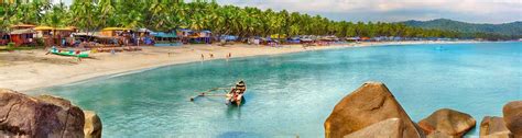 a beach scene with boats and people in the water, surrounded by palm tree's