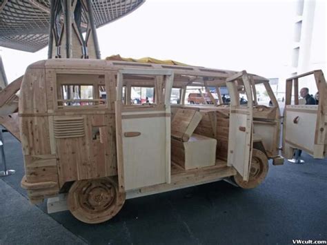 an old wooden vehicle is parked in a parking lot