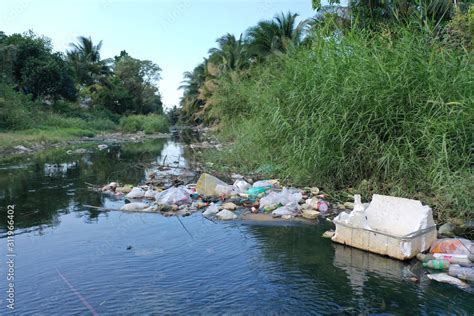 Water pollution. Raw sewage and plastic trash dumped in stream in poor ...