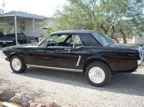 Nice setup on this black 65 Mustang with those solid wheels...