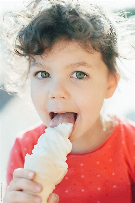 «Portrait Of A Cute Little Girl Eating An Ice Cream Cone» del colaborador de Stocksy «Lea ...