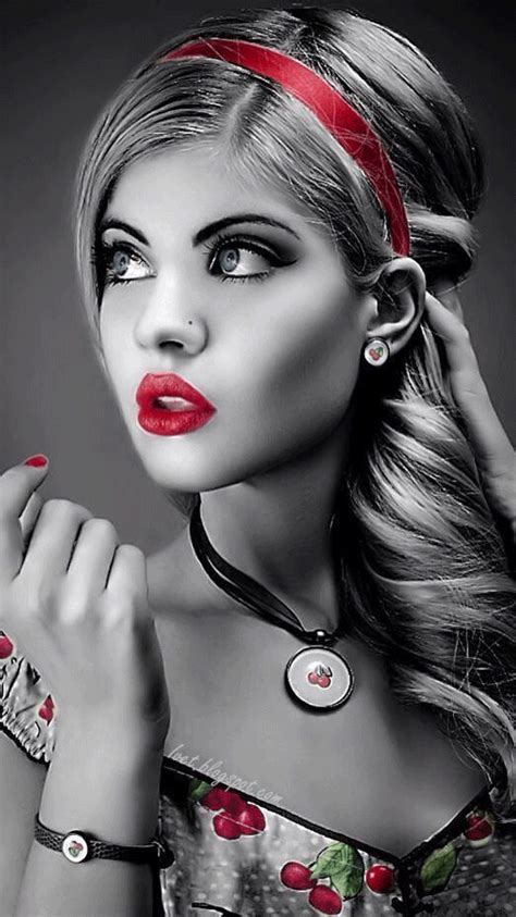 a woman with long hair and red lipstick is posing for a black and white ...
