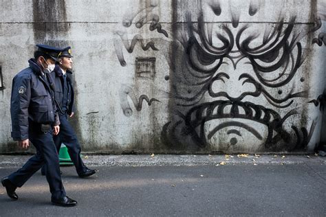 Tokyo police officers and a grimacing graffiti face — Tokyo Times