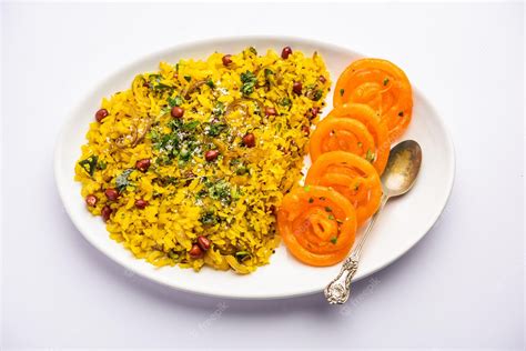 Premium Photo | Aloo poha with jalebi snack combination also called imarti and kande pohe