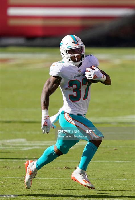 Myles Gaskin of the Miami Dolphins carries the ball against the San... | Miami dolphins ...