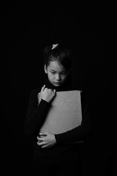 Toddler Girl Holding Gray Book · Free Stock Photo