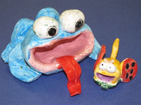 4th grade ceramic frog with bug; approx. 6" and 2 1/2" wide; lesson by art teacher: Susan Joe ...
