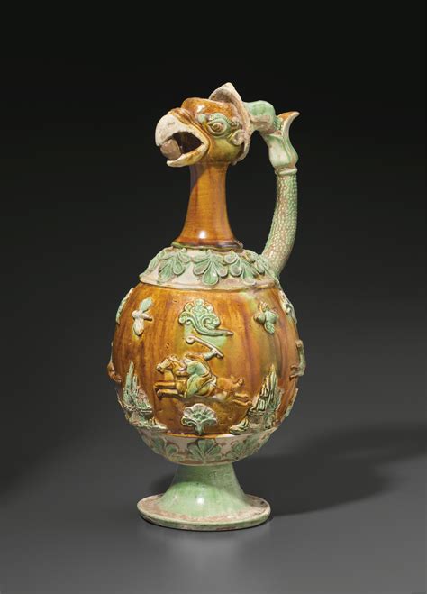 A VERY RARE SANCAI-GLAZED POTTERY PHOENIX-HEAD EWER , CHINA, TANG DYNASTY (AD 618-907) | Christie's