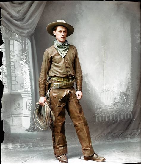 a man in a cowboy outfit is posing for a photo