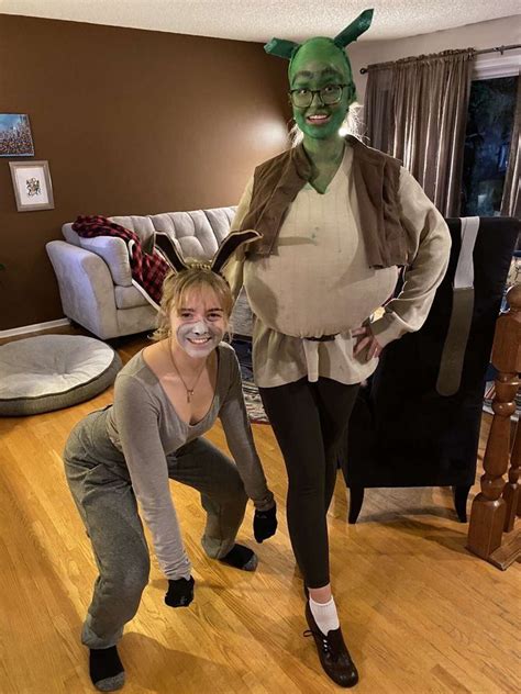 two people in costumes standing on a wooden floor