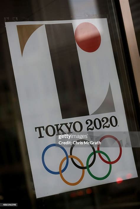 The Tokyo 2020 Olympic logo is seen on a poster hung at the entrance ...