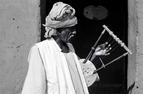 Musician - traditional musician playing "Rababa" which is a Sudanese music instrument similar to ...