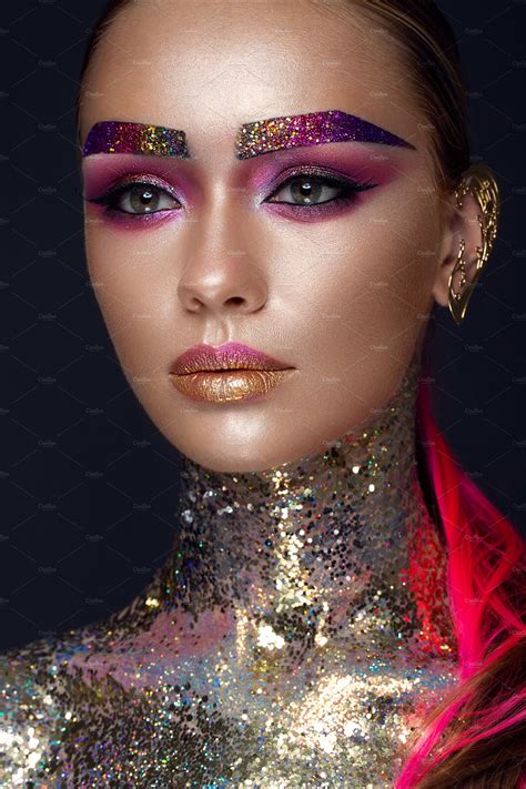 Beautiful girl with creative glitter makeup, sparkles, unusual eyebrows ...