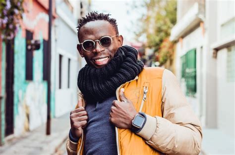 Premium Photo | Waist up portrait of young black man smiling standing ...