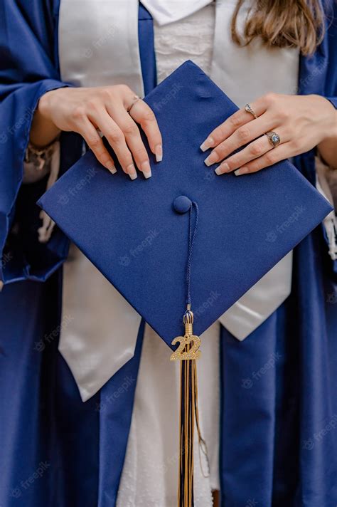 Premium Photo | A graduate wearing a blue graduation cap and a gold tassel.