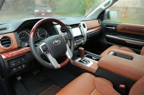 the interior of a vehicle with brown leather and wood trims, including ...