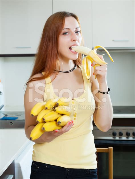 Long-Haired Woman Eating Banana Stock Photo | Royalty-Free | FreeImages