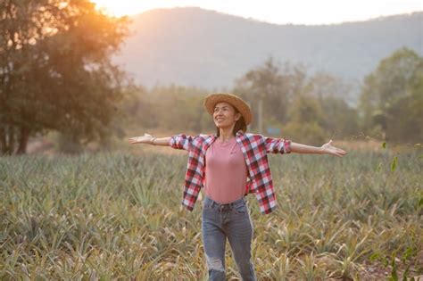 Free Photo | Asian female farmer see growth of pineapple in farm, Young pretty farmer woman ...