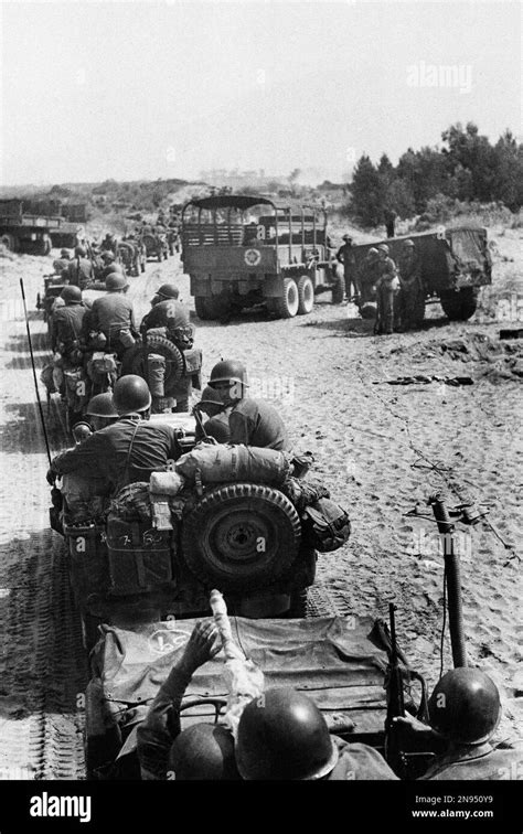 A long line of jeeps carrying troops of the U.S. Fifth Army moves inland from the Salerno ...