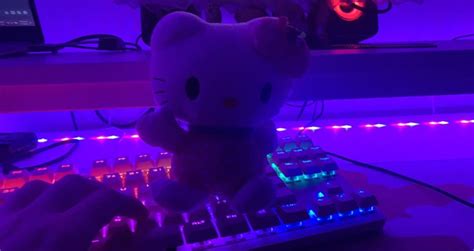 a hello kitty stuffed animal sitting on top of a keyboard