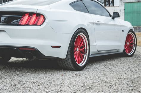 Striking Contrast: Custom Red Vossen Wheels on White Ford Mustang ...