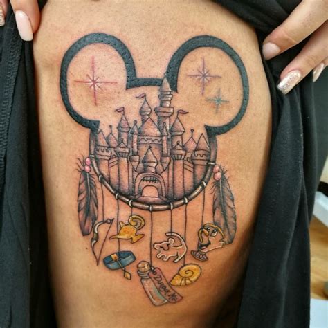 a woman's thigh with an image of a castle and some other things on it