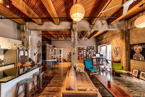 The exposed brick, oak-wood flooring, concrete pillars, and open space ...