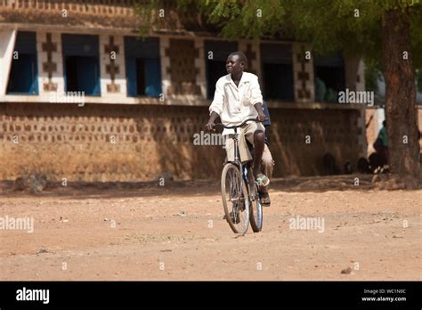 TORIT, SOUTH SUDAN-FEBRUARY 20, 2013: Unidentified student rides his ...