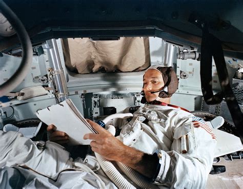 Mike is seen inside the Apollo 11 Command Module looking over flight ...