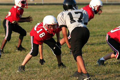 Americans love football, but differ on whether kids should play