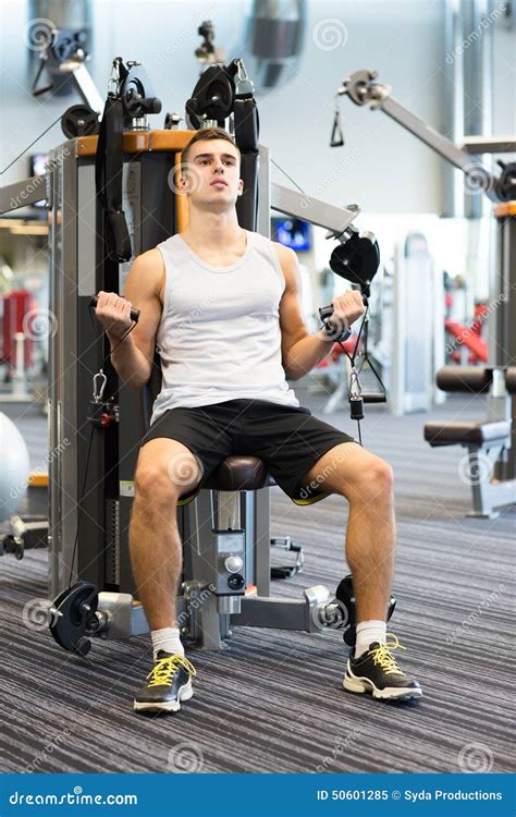 Man Exercising On Gym Machine Stock Photo - Image: 50601285