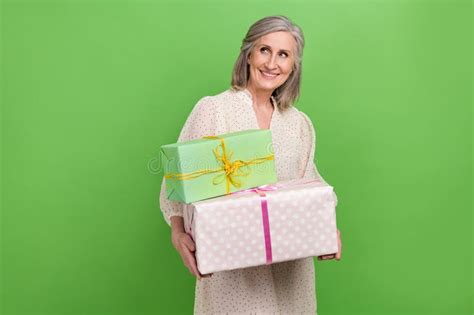 Photo of Pretty Adorable Woman Dressed Beige Outfit Holding Gifts Looking Empty Space Isolated ...