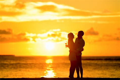 Couple Standing in the Seashore Hugging Each Other during Sunset · Free Stock Photo