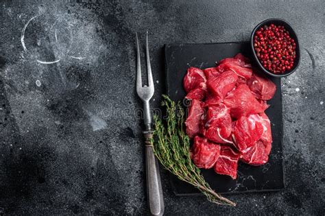 Raw Diced Red Beef Meat for Goulash on Marble Board. Black Background ...