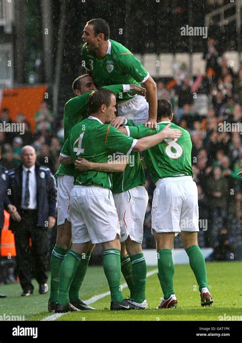 Republic of Ireland's Robbie Keane celebrates scoring the opening goal of the game with team ...