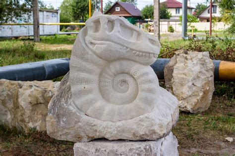 Ammonite with Dinosaur Head. Sculpture Made of White Limestone and ...