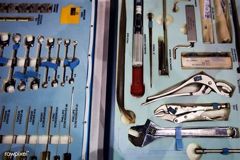 STS-135 crew members inspect tools they will use in space during the ...