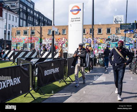 Shoreditch, London, England, UK - April 2019: People walking near Shoreditch high street station ...